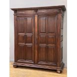 A French cherry wood armoire, 19th century, the dentil cornice above two doors with fielded panels