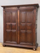 A French cherry wood armoire, 19th century, the dentil cornice above two doors with fielded panels