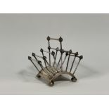 Christopher Dresser for Hukin & Heath, a silver-plated six-division toast rack, on an arched base