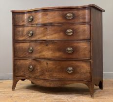 A George III mahogany serpentine chest, fitted with four graduated long drawers, raised on splayed
