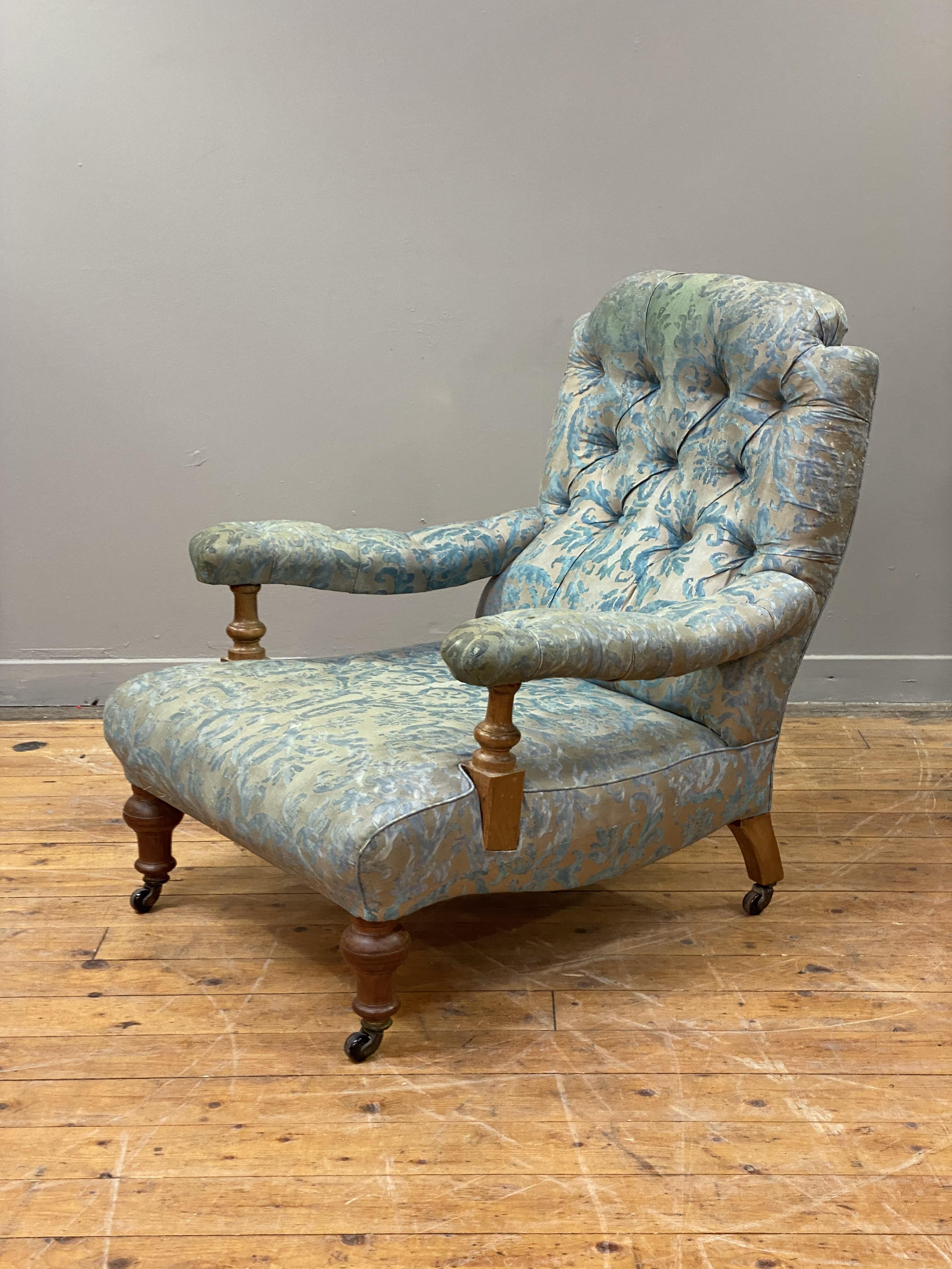 Attributed to James Shoolbred, a Victorian walnut-framed country house open armchair, standing on