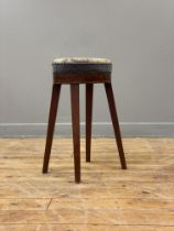 An early 19th century mahogany high stool, the seat upholstered in embroidered fabric worked in a