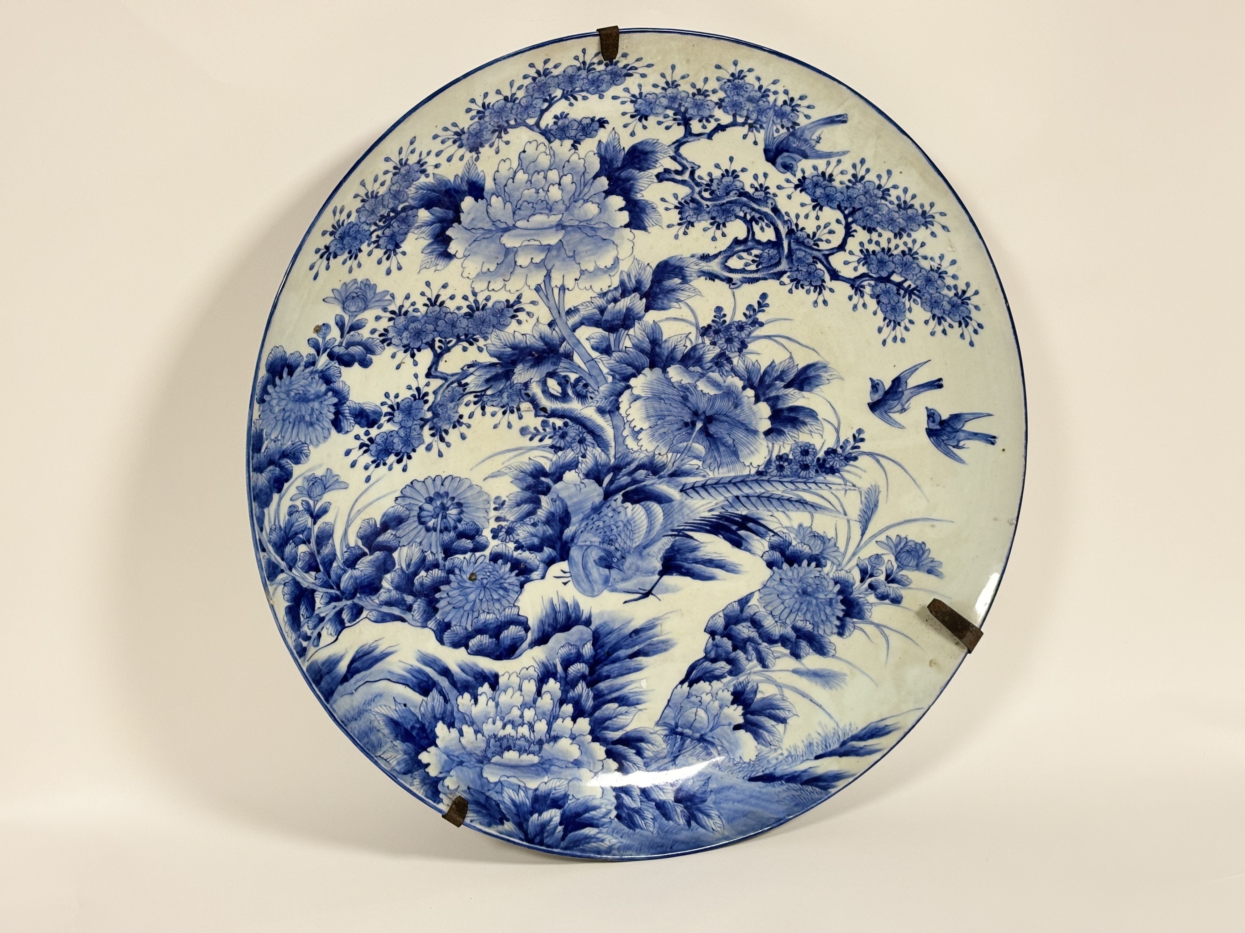 A monumental Meiji period Japanese Arita yaki sometsuke porcelain blue and white dish painted with