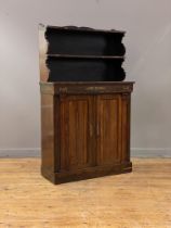 A Regency rosewood chiffonier, the raised back with two open shelves, above a frieze drawer with
