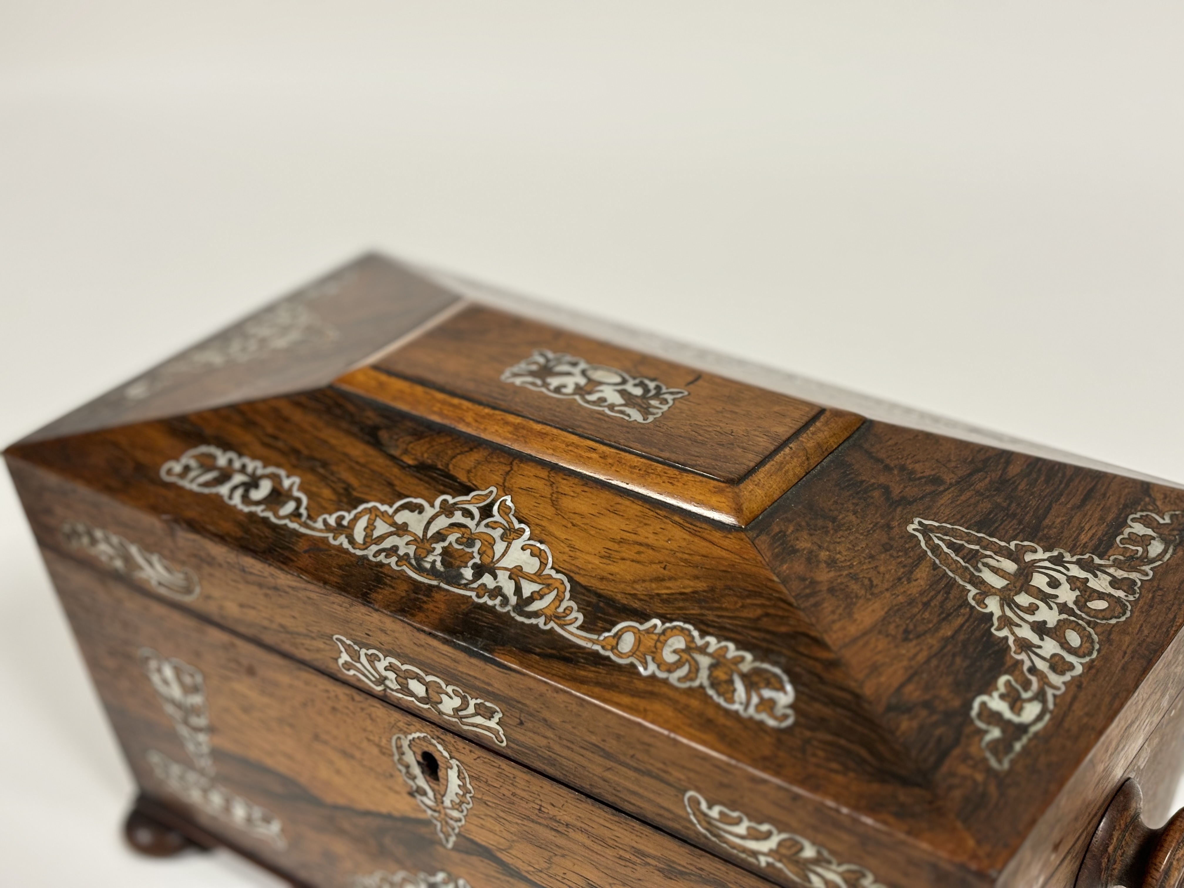 A William IV mother-of-pearl inlaid rosewood tea caddy, of sarcophagus shape, with turned handles - Image 8 of 8