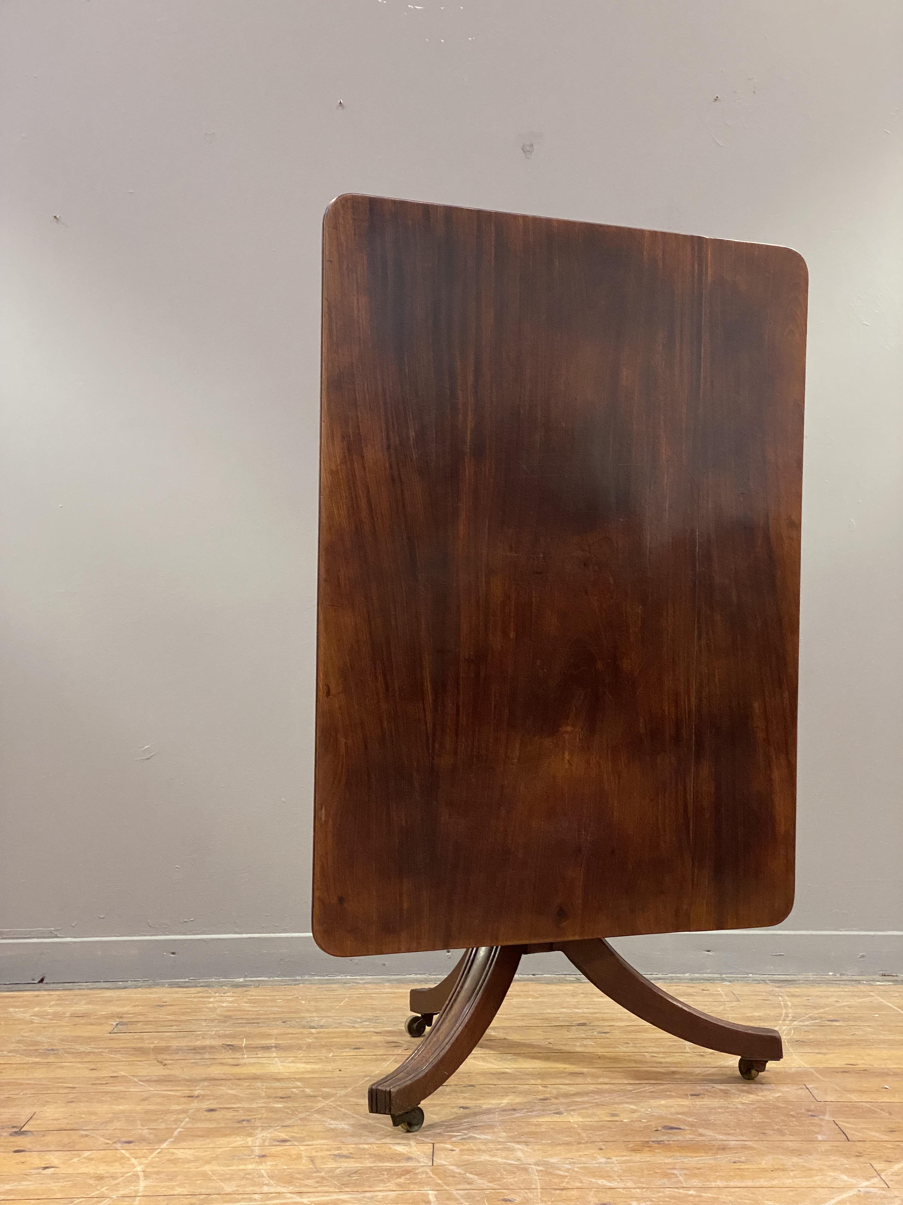 A Regency mahogany tilt top breakfast table, the rectangular top raised on a turned column and - Image 2 of 3
