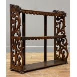 A Victorian oak three height table or wall rack, each shelf with a shaped and carved apron, with