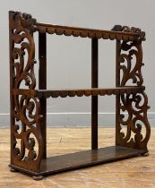 A Victorian oak three height table or wall rack, each shelf with a shaped and carved apron, with