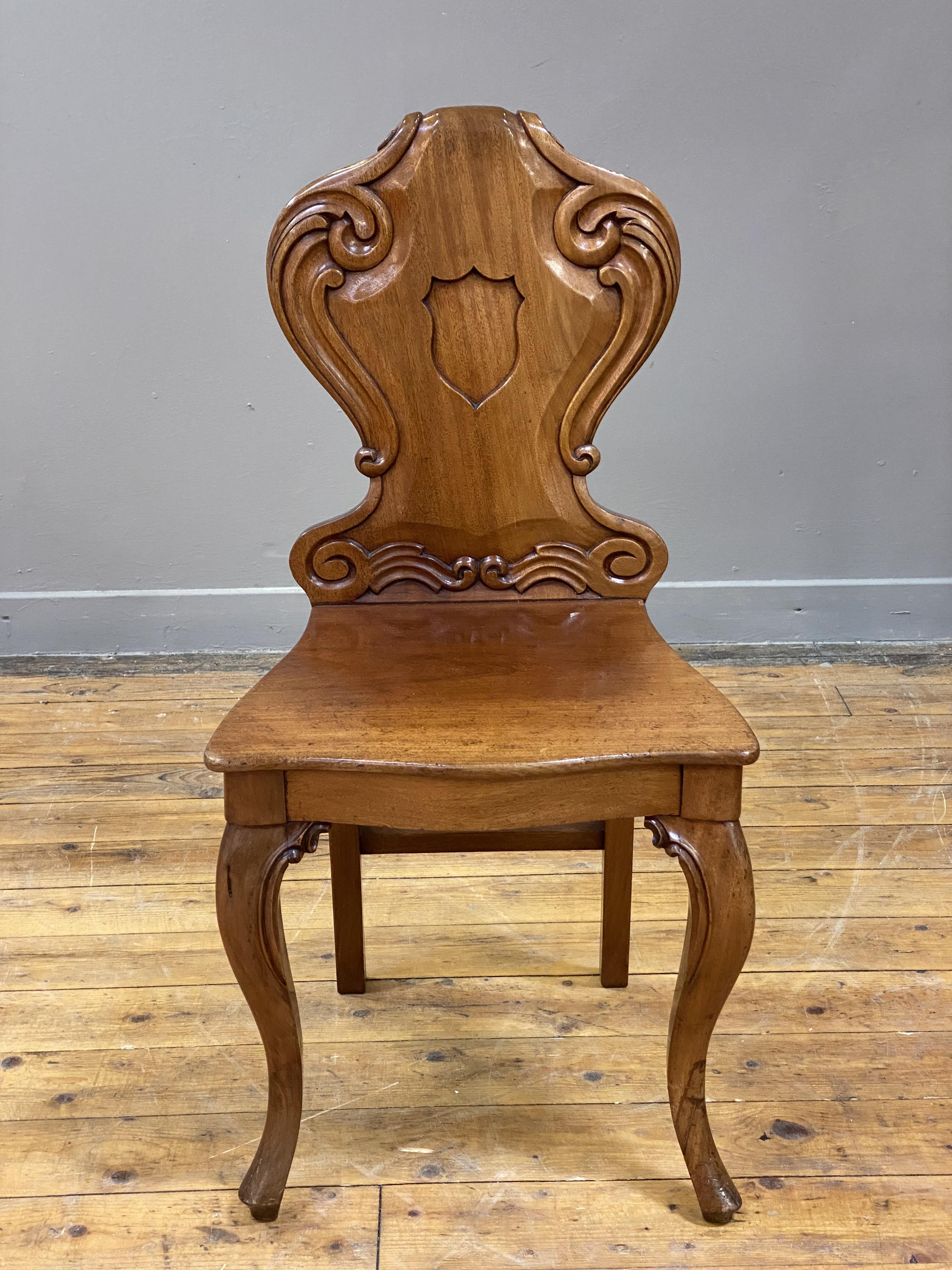 A Victorian mahogany hall chair, the scroll carved back of cartouche form above a panel seat with - Image 2 of 2