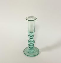 A late 18th / early 19th century glass candlestick, with elongated cylindrical cup on a knopped
