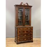 A George III mahogany bookcase on chest, the swan neck pediment with boxwood paterae, above two