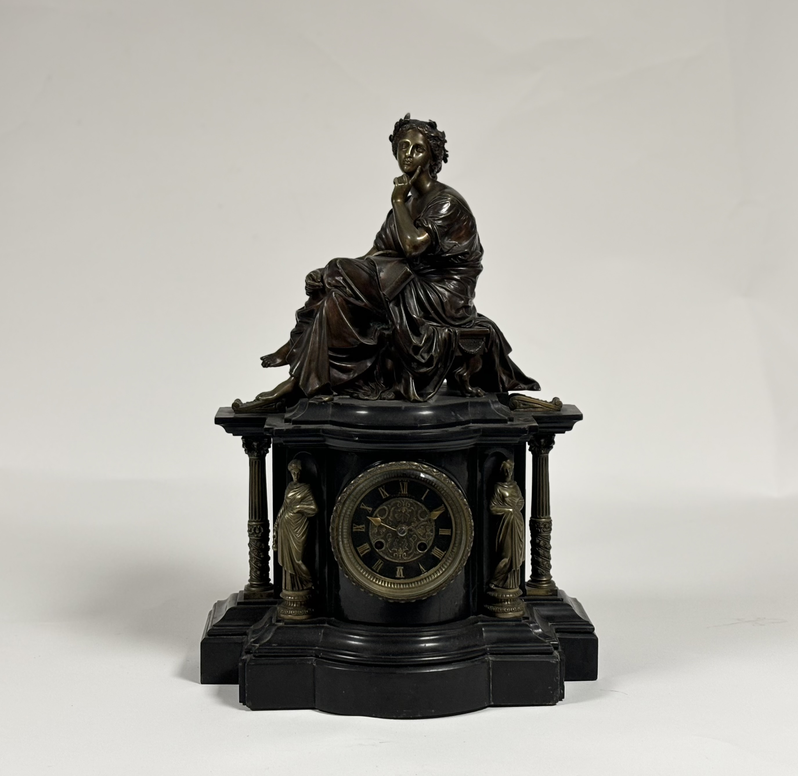 A French patinated and gilt bronze mounted slate mantel clock, late 19th century, the well-cast