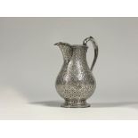 A mid-Victorian silver baluster cream jug, Edward & John Barnard, London 1863, densely engraved with