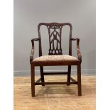 A George III elm elbow chair, late 18th century, the undulating crest rail and uprights with