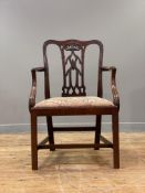 A George III elm elbow chair, late 18th century, the undulating crest rail and uprights with