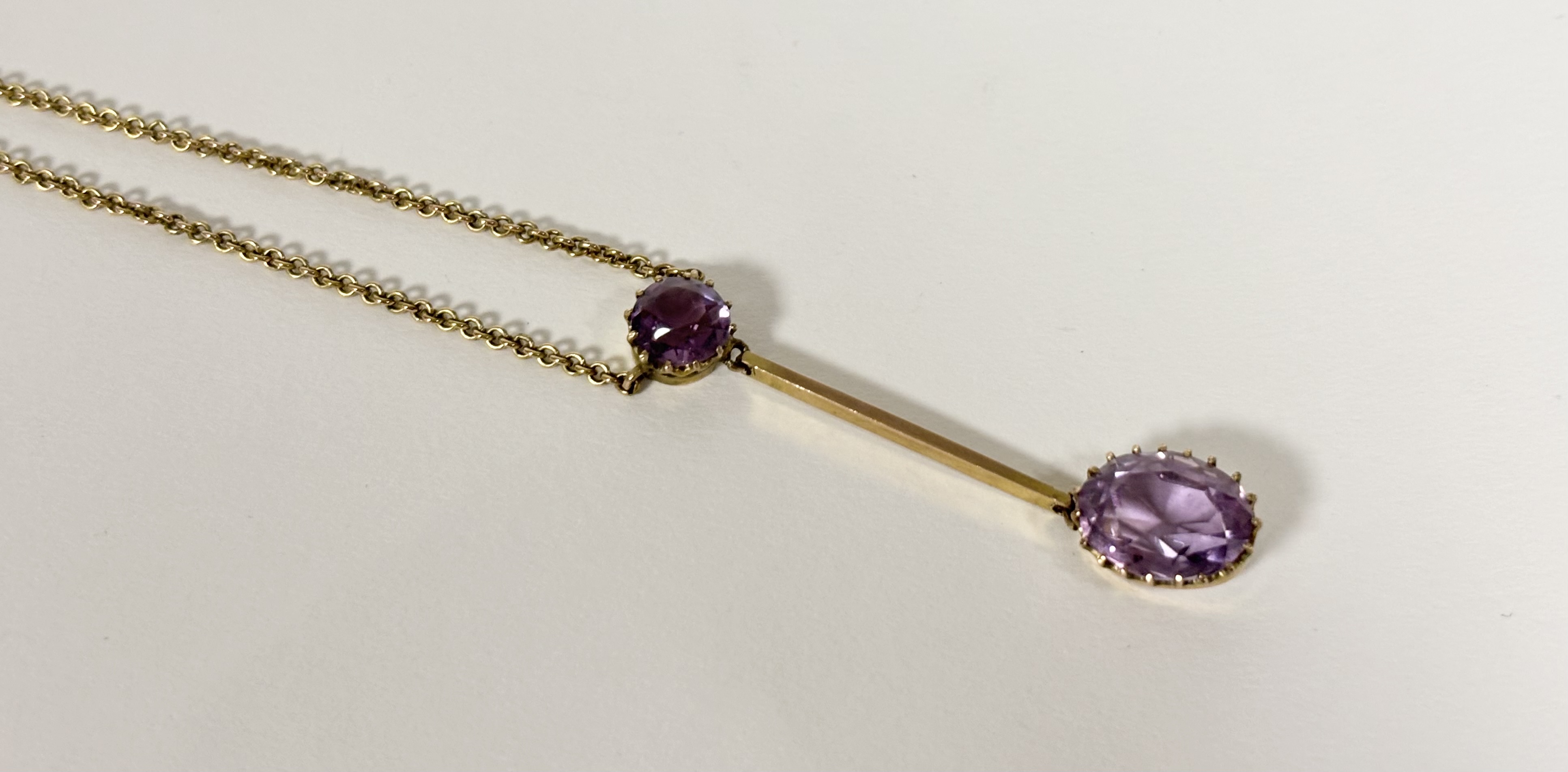 An Edwardian 9ct gold amethyst bar pendant the oval-cut amethyst claw-set and suspended from a - Image 4 of 4