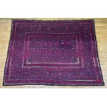 A large Turkoman Suzani wall hanging, circa 1900, the purple ground embroidered with interlaced