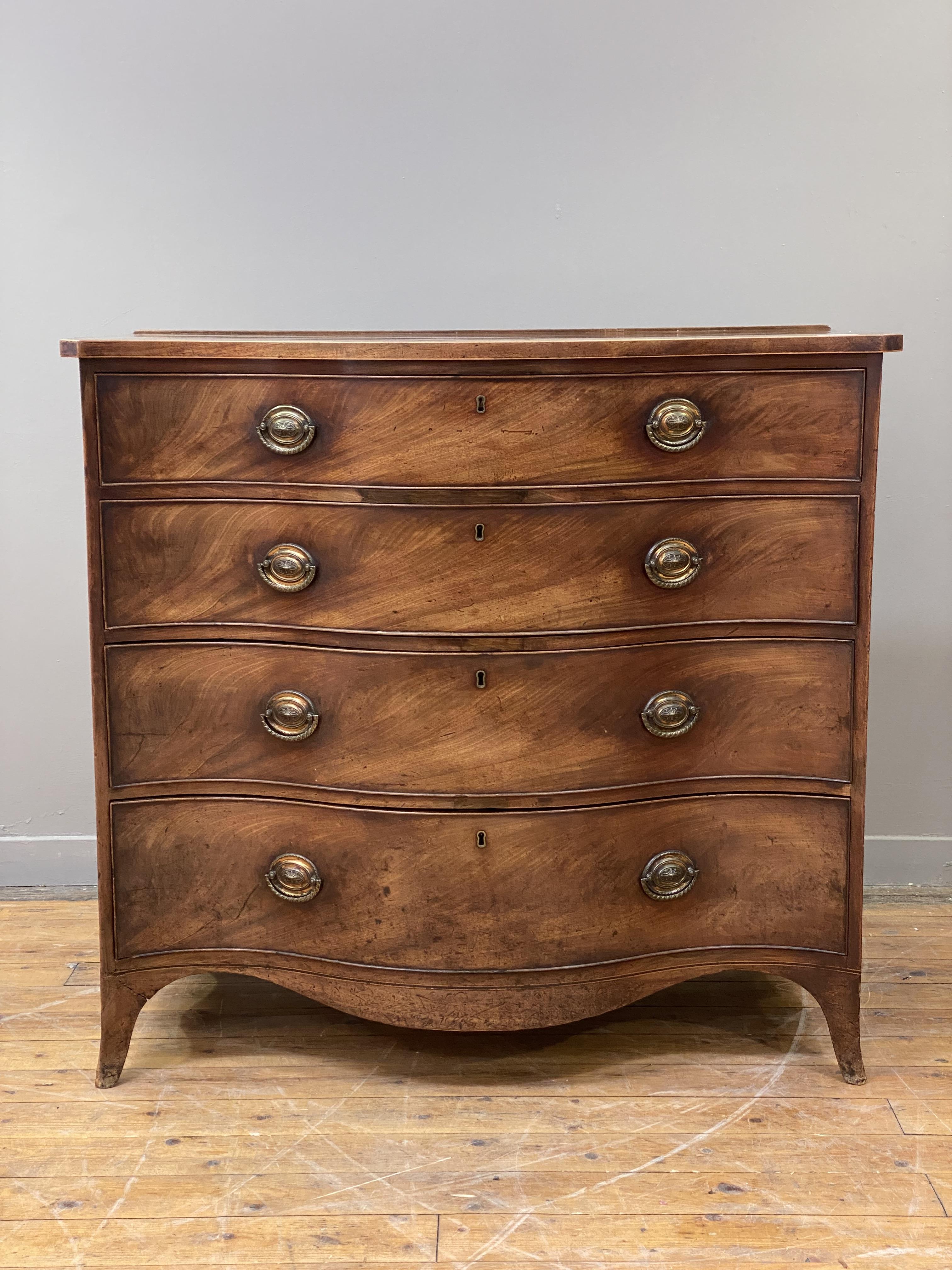 A George III mahogany serpentine chest, fitted with four graduated long drawers, raised on splayed - Image 2 of 3