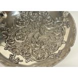 A Continental silver centre bowl, circular, the well repousse with scrolling foliage, raised on