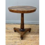 A William IV rosewood pedestal table, the circular top raised on a turned and tapered column with