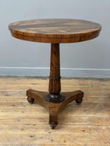 A William IV rosewood pedestal table, the circular top raised on a turned and tapered column with