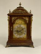 A large late 19th / early 20th century bracket clock, the domed mahogany case with four acorn finals