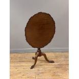 A 19th century mahogany tilt top table, the circular top with raised and moulded edge above a ring