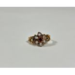 A mid-19th century emerald, ruby or garnet and seed pearl ring, set to the centre with a heart-cut