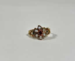 A mid-19th century emerald, ruby or garnet and seed pearl ring, set to the centre with a heart-cut