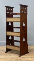 An Arts and Crafts period cherry three tier book stand, each sloping shelf having an applied