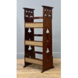 An Arts and Crafts period cherry three tier book stand, each sloping shelf having an applied