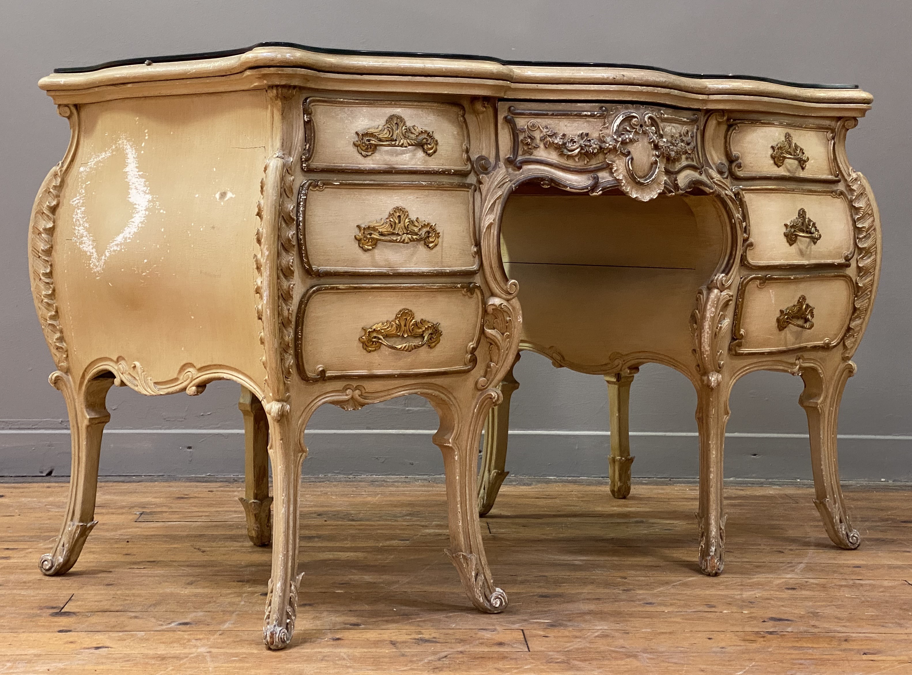 A Neo-Rococo dressing table or desk, late 19th century, cream painted and parcel gilt hardwood,