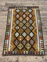 A maimana kilim rug with repeating lozenge design and running dog border. 191cm x 127cm.