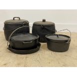 A graduated pair of enamelled metal cooking pots, together with an assortment of pans, cast iron