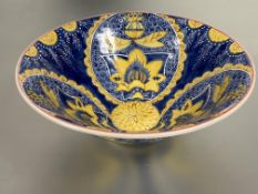 A large eastern porcelain salad bowl with inner and outer oval panels decorated with yellow lotus