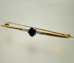 A 9ct gold bar brooch set oval sapphire approximately 0.25ct mounted in claw setting flanked by