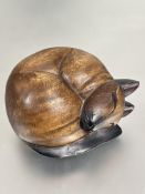A carved wood curled sleeping Siamese cat figure with black points H x 12cm D x 16cm