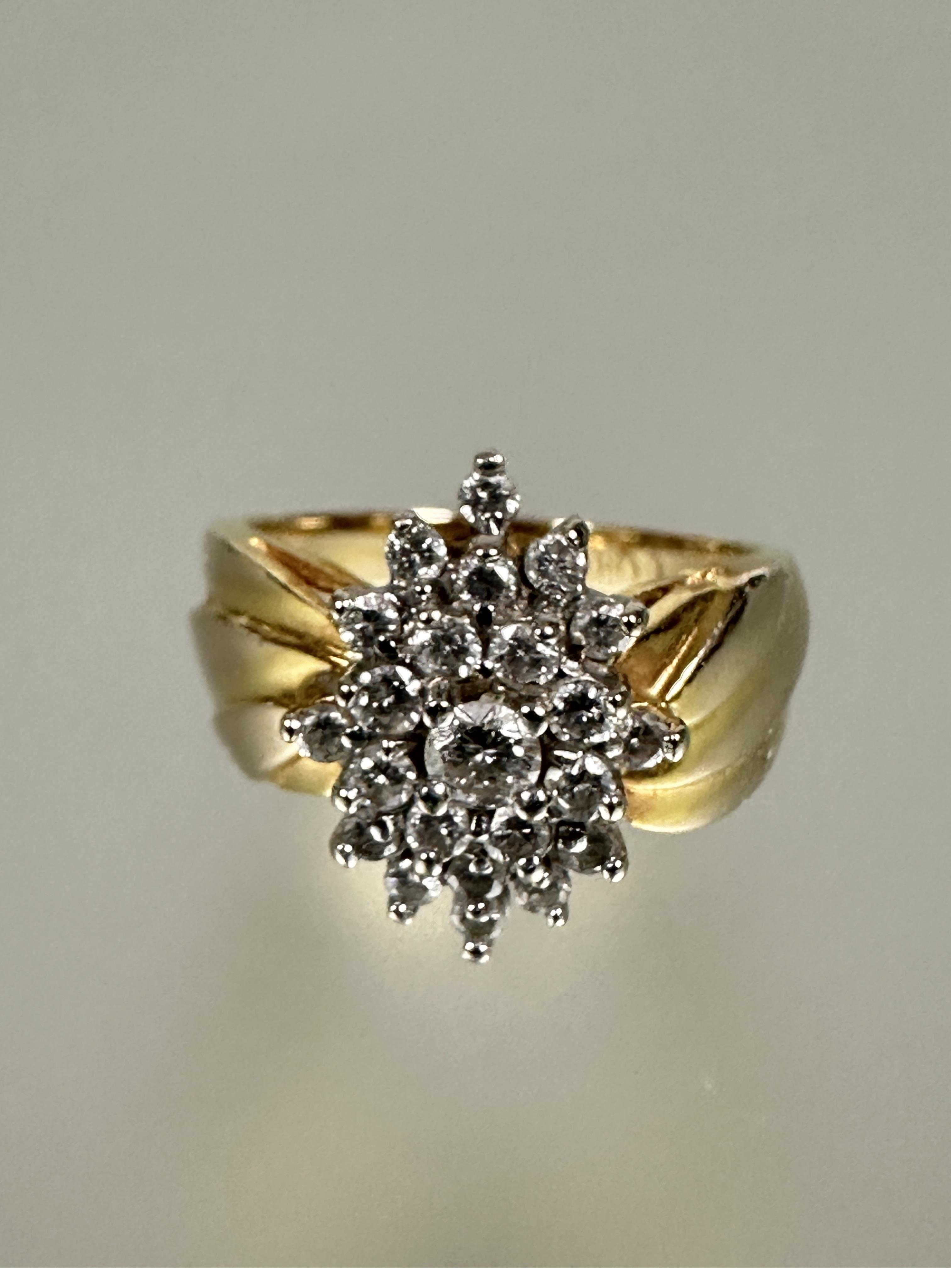A 14ct gold diamond cluster ring the center brilliant cut stone 0.15ct  within a surround of
