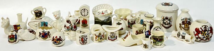 A large quantity of souvenir heraldic china including several items of W.H. Goss (furthest right,