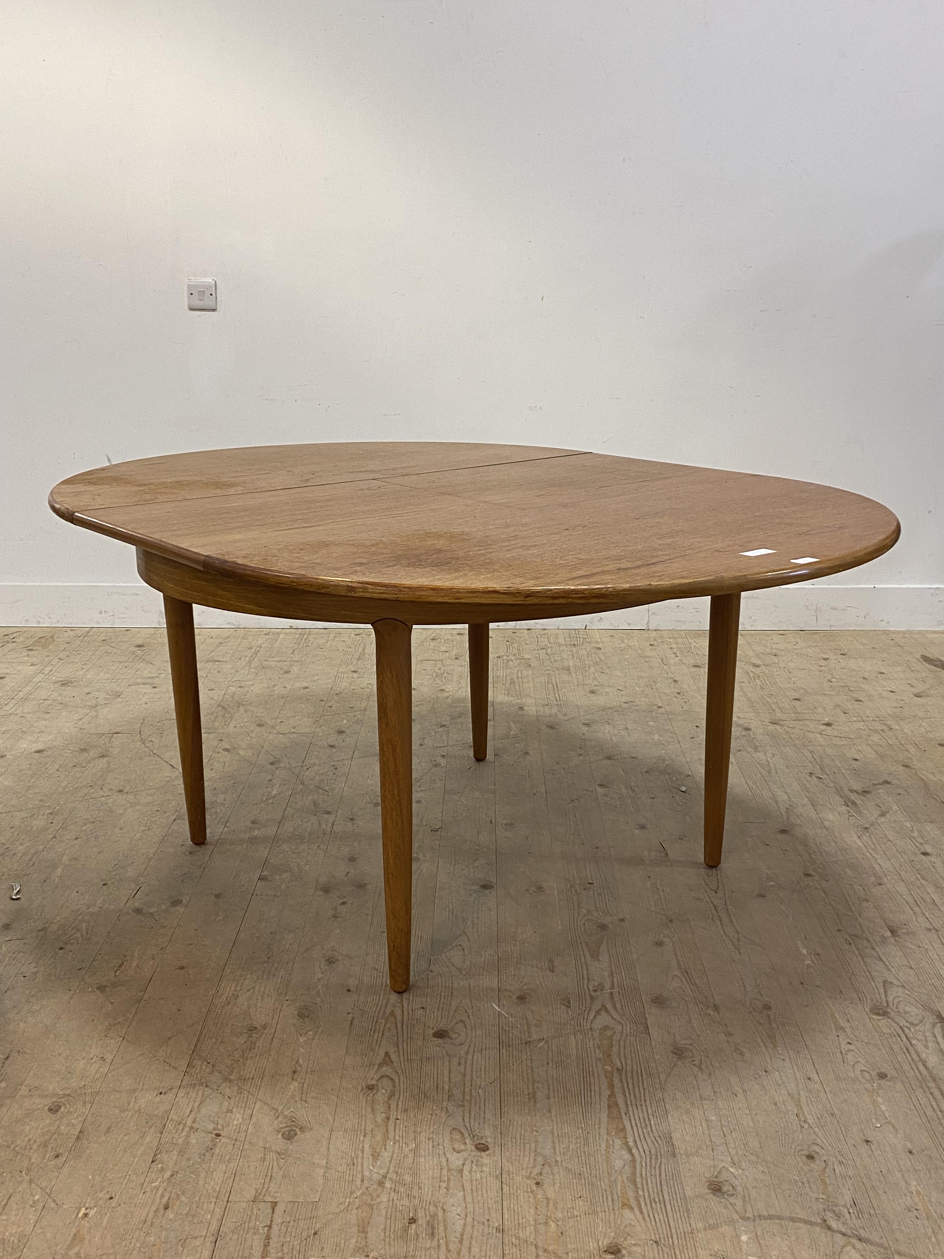 A mid century teak circular dining table with magic leaf to centre and raised on turned and - Image 2 of 3