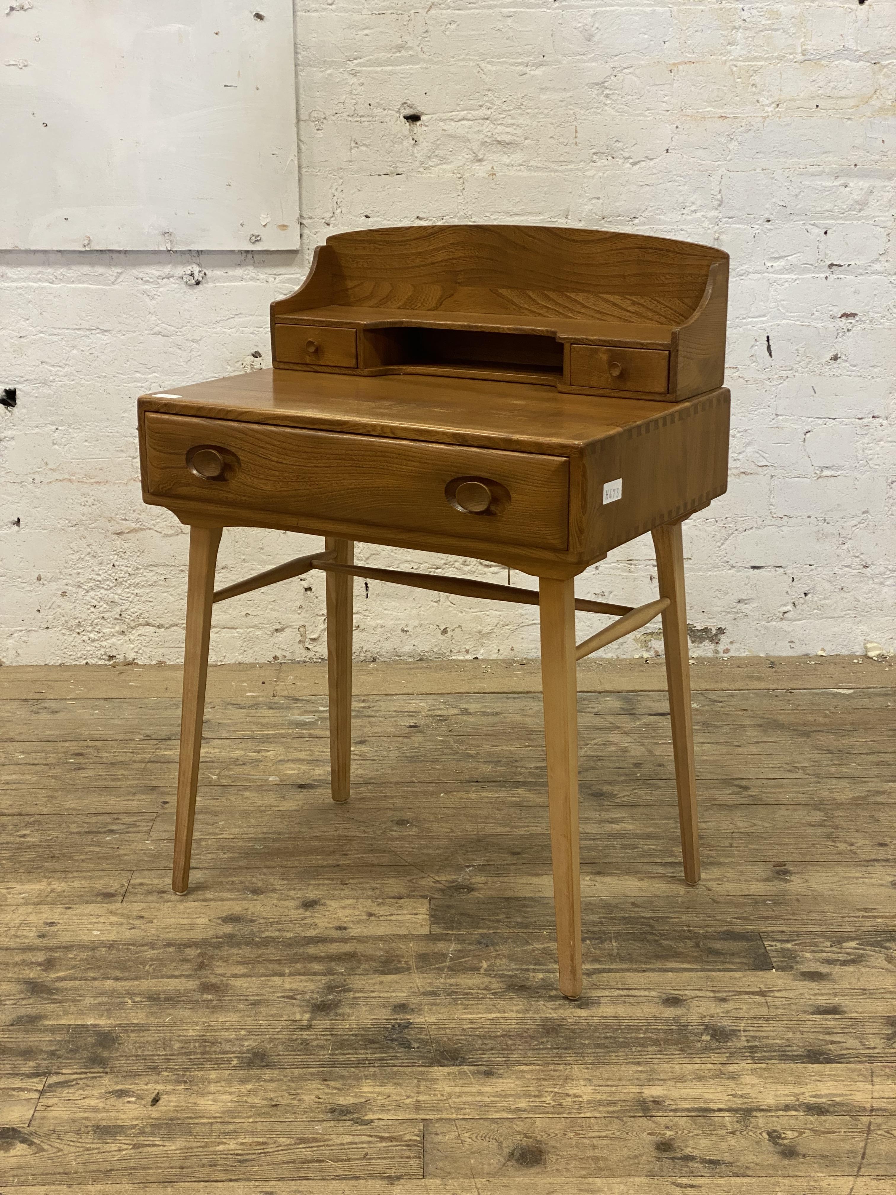 Ercol, an elm and beech writing desk, the superstructure with two drawers and open shelf, above a