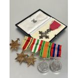 A group of medals to include an MBE cased, together with a WWII group of medal including, an