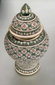 A Baan Celadon Chiang Mai Thai baluster vase and cover decorated with all over hand painted floral
