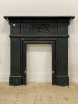 A late 19th century cast iron fire insert, the frieze decorated with urn and floral bouquet motif.