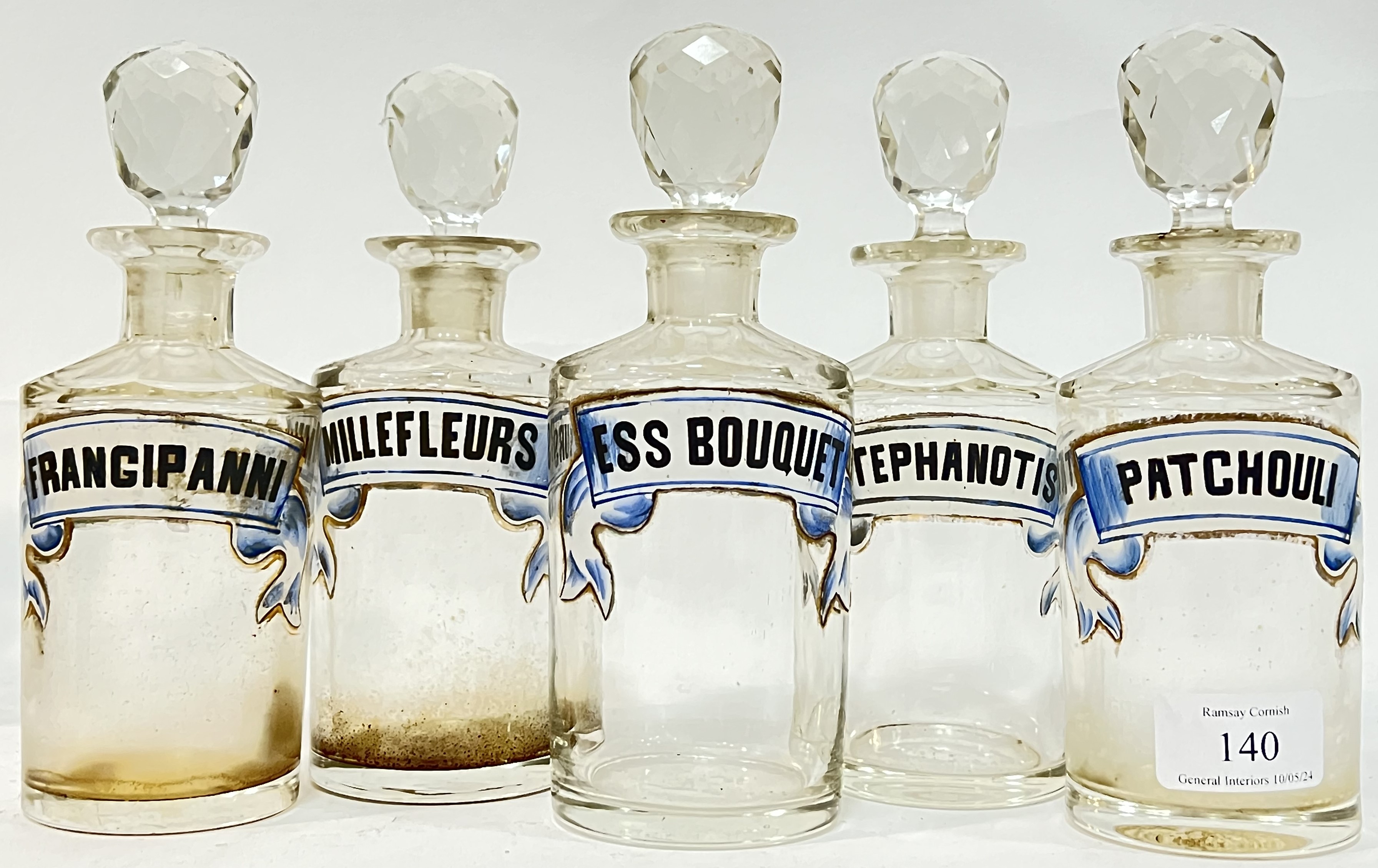 Five unusual faceted glass chemist/apothecary jars/bottles with enameled labels (possibly