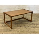 A mid century teak coffee table, cross banded top raised on shaped end supports. H47cm, 102cm x