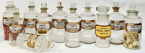 A group of clear glass chemist/apothecary jars with gilt verre eglomise labels (medicines removed,