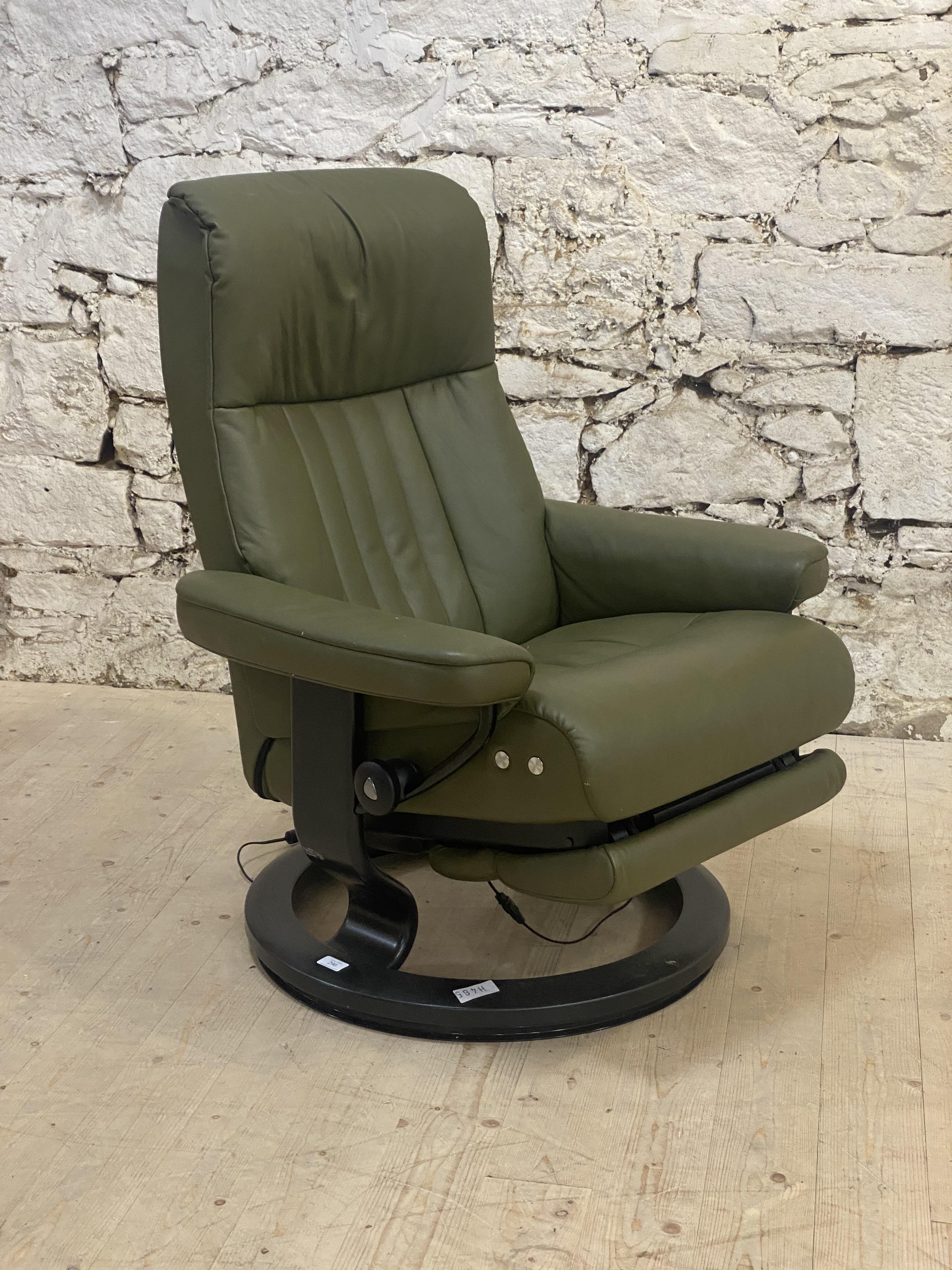 A Vintage Ekornes Stressless electric reclining lounge chair, upholstered in green leather and