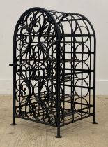 A wrought metal wine rack of arched form, decorated with scrolls. H69cm.