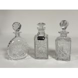 A collection of decanters comprising, one with spherical crystal decanter with stopper (h-26cm)
